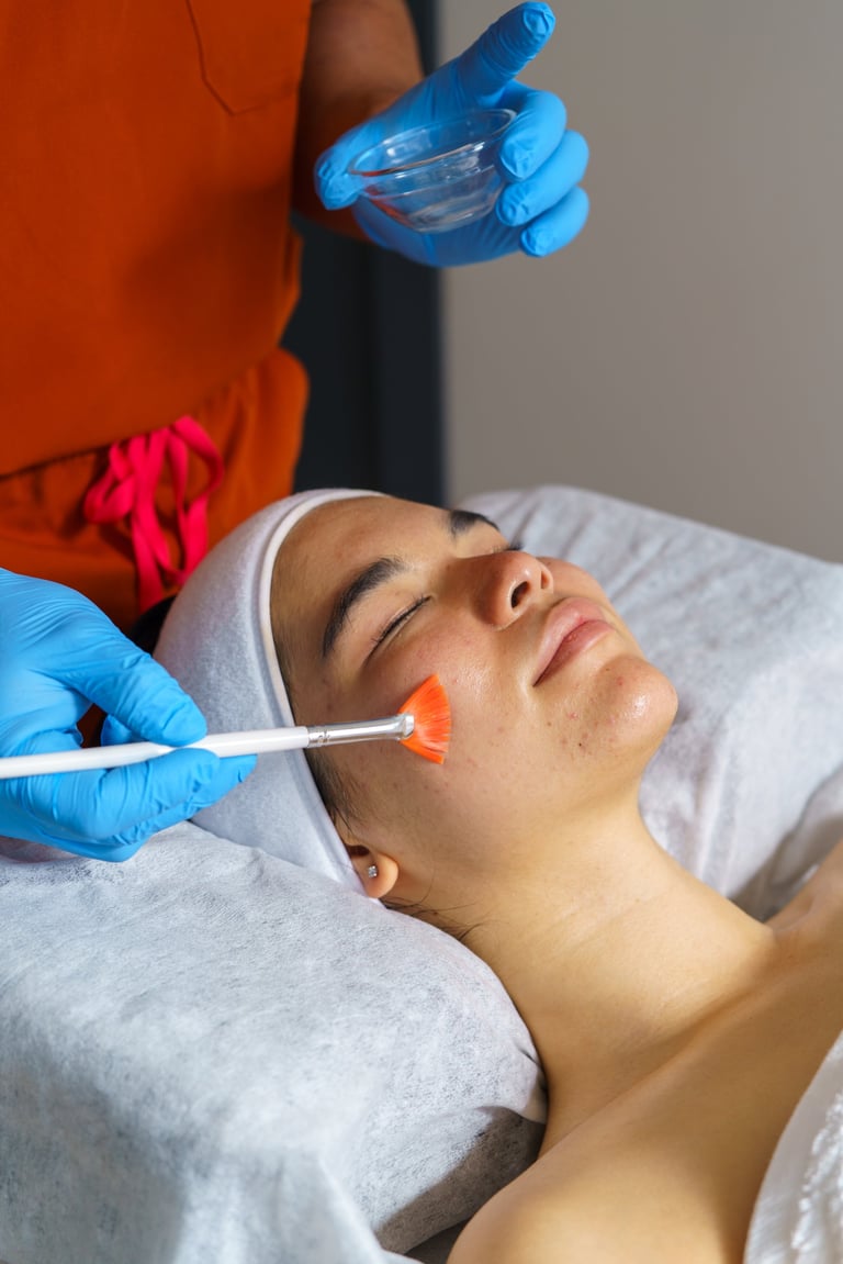 Beautician applying chemical peel treatment